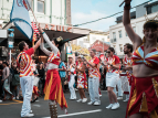 Wellington Batucada drummers and dancers parade at CubaDupa. Photo by Bokeh Street.